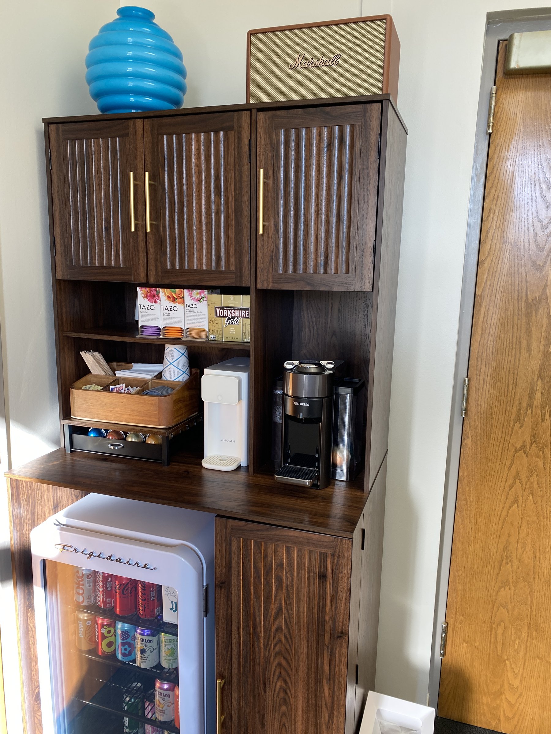 Beverage station with complimentary coffee, tea, and cold drinks for therapy clients