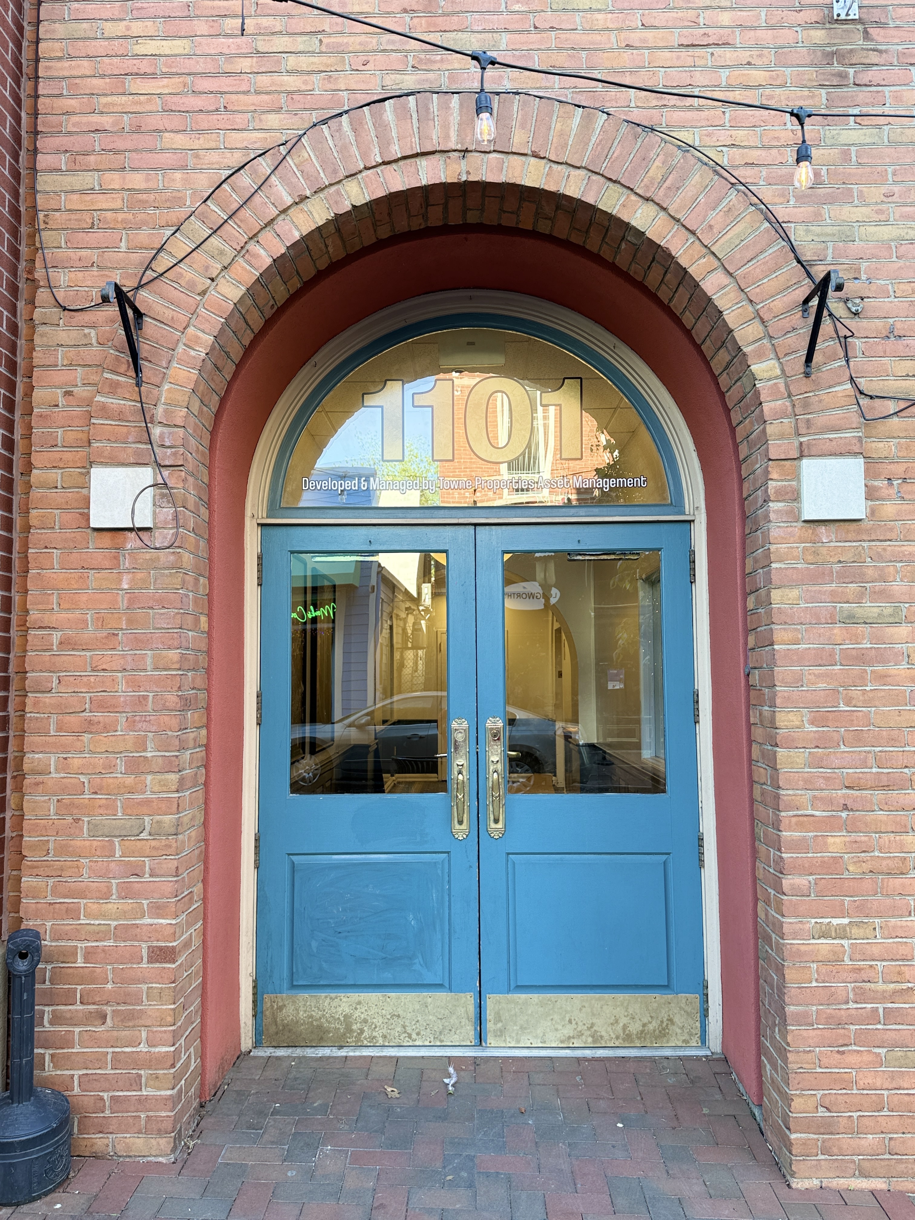 The blue arched entrance door at 1101 Saint Gregory Street