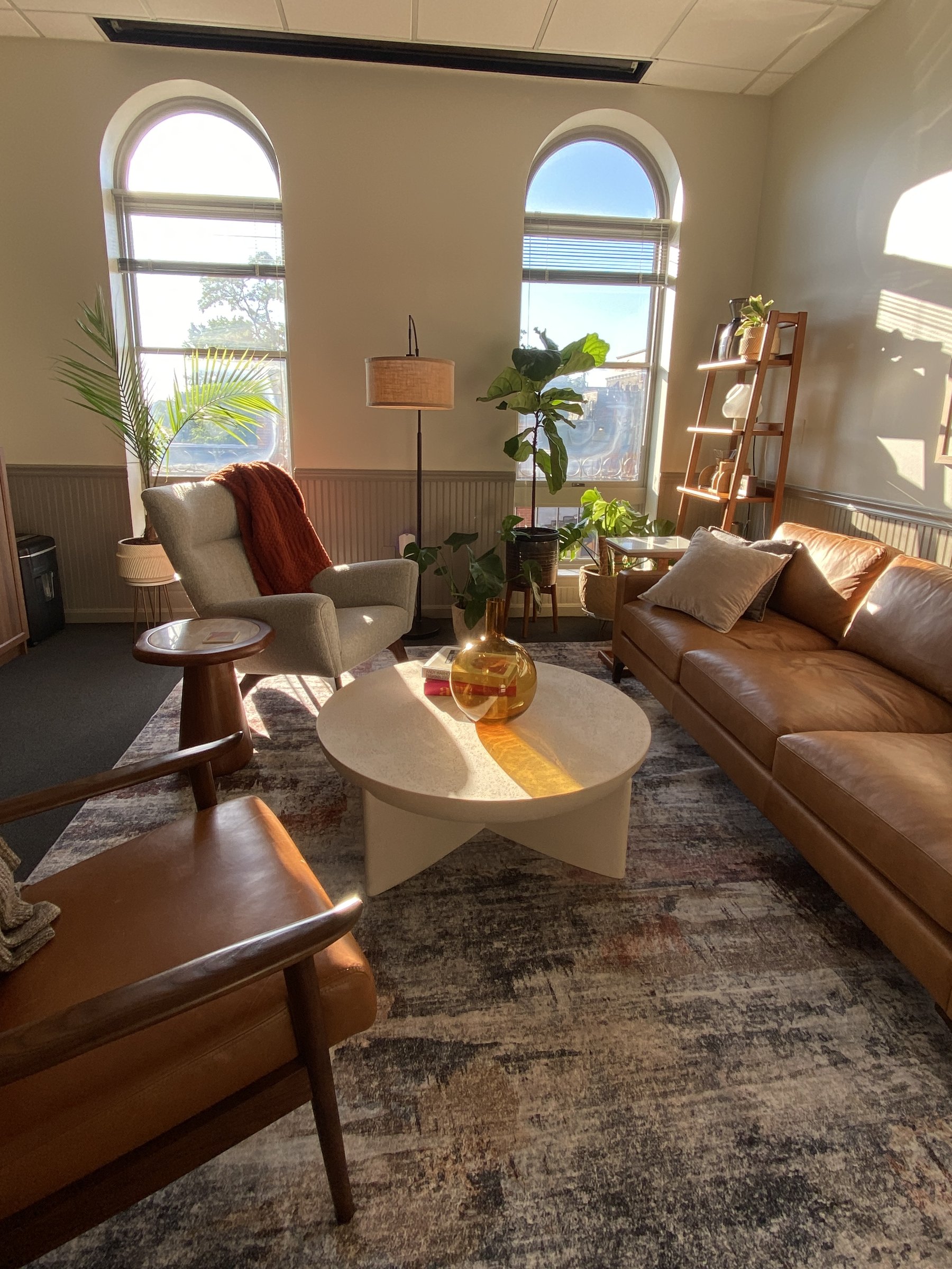 Therapy office with leather seating and arched windows in Mt. Adams, Cincinnati